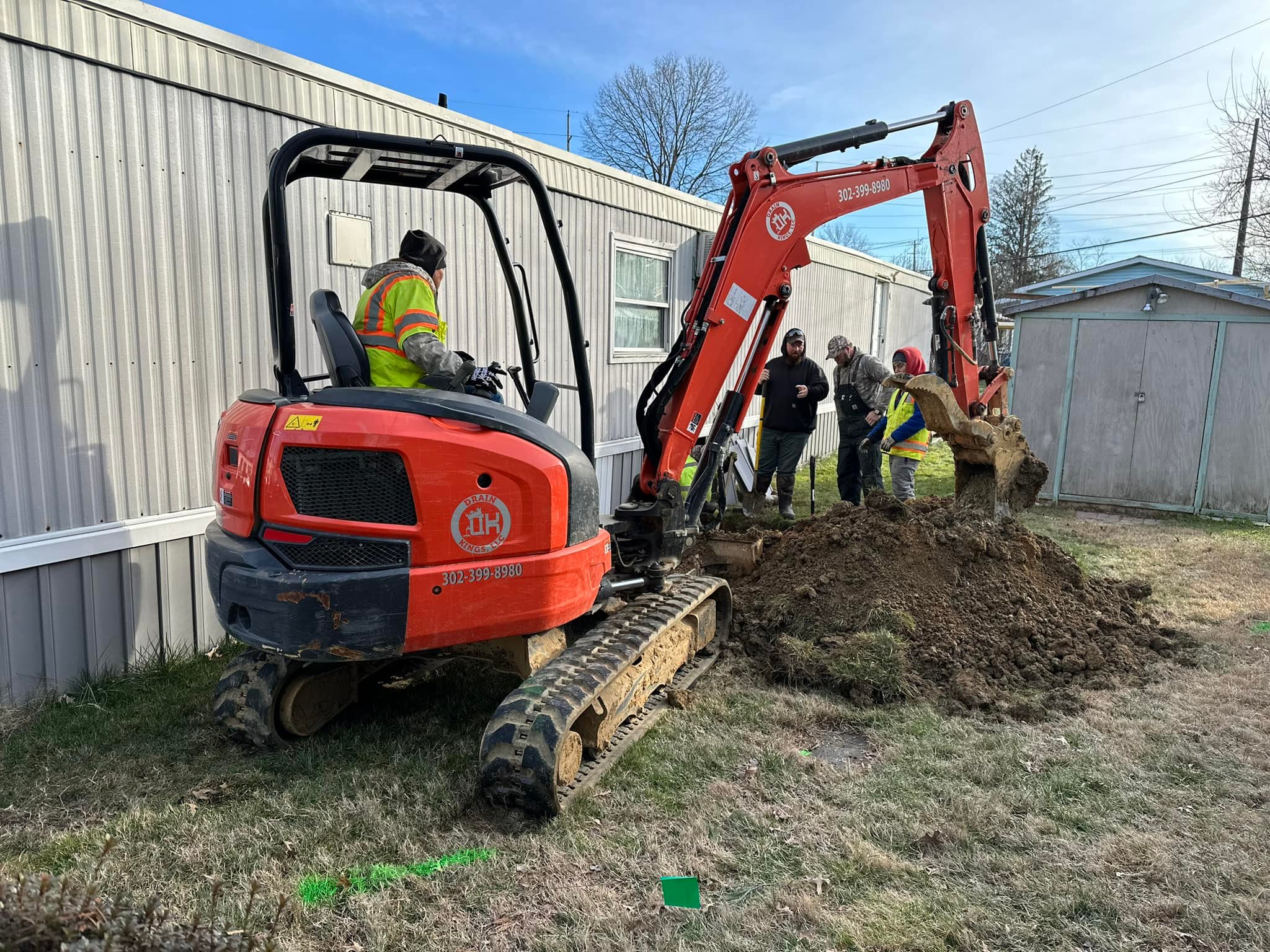 Owner Mike Ferrell on site with a mini excavator during a utility dig